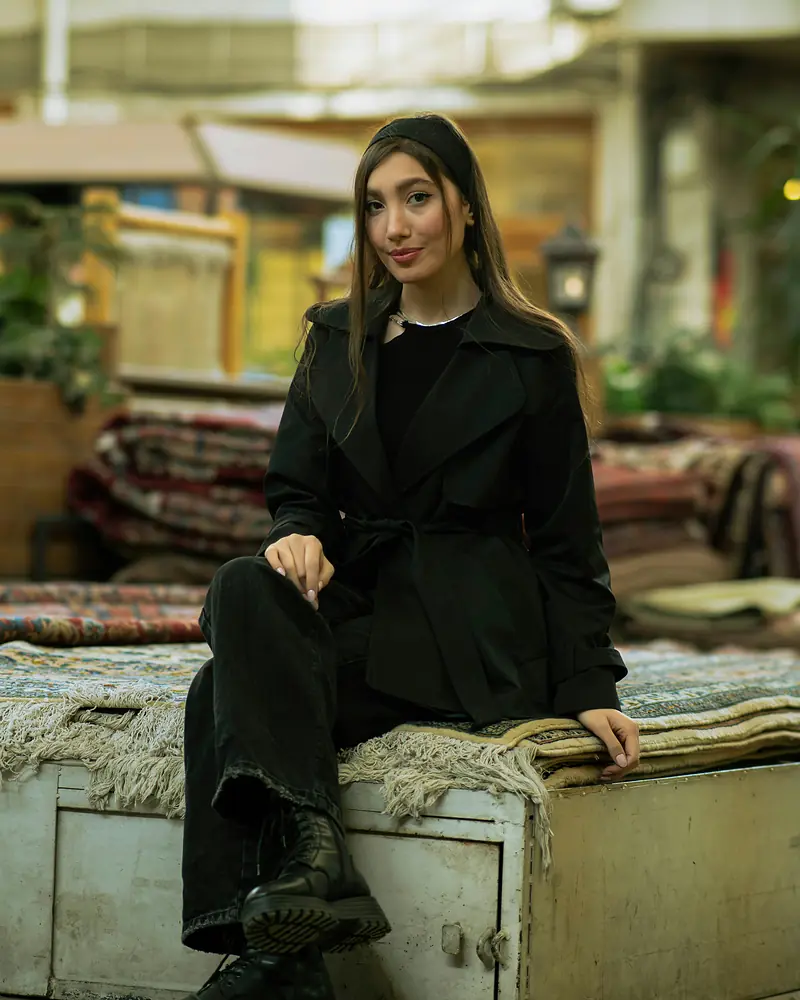 The Oversized Trench in black, seated
