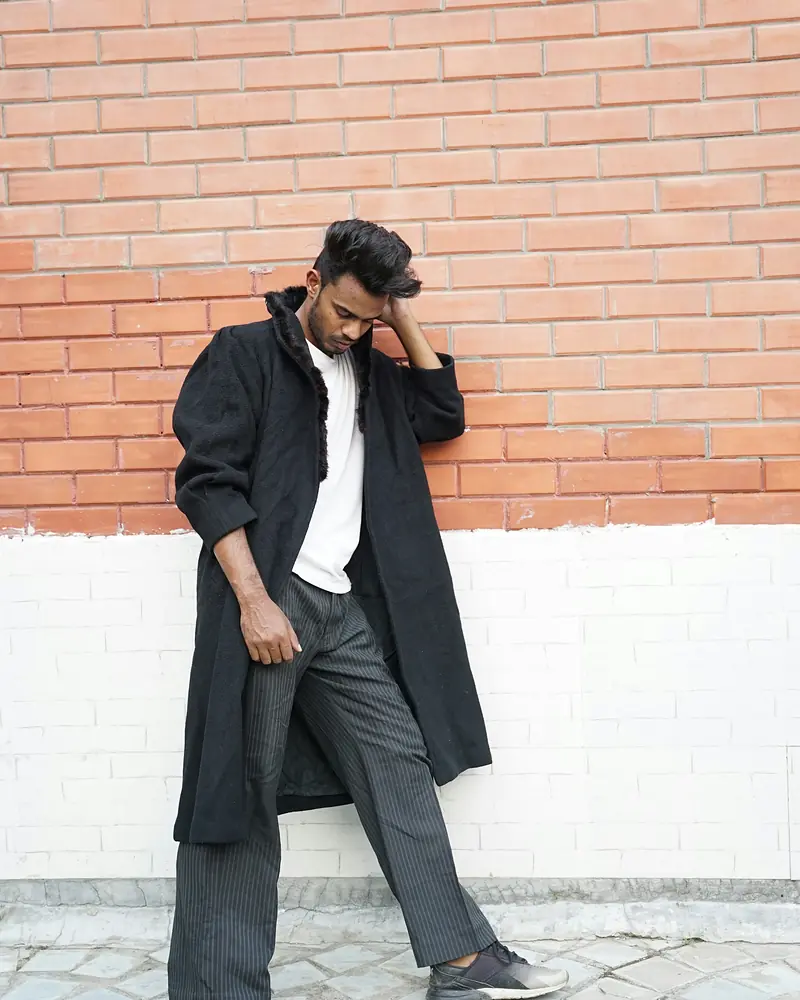 The Oversized Trench in black, styled on a man